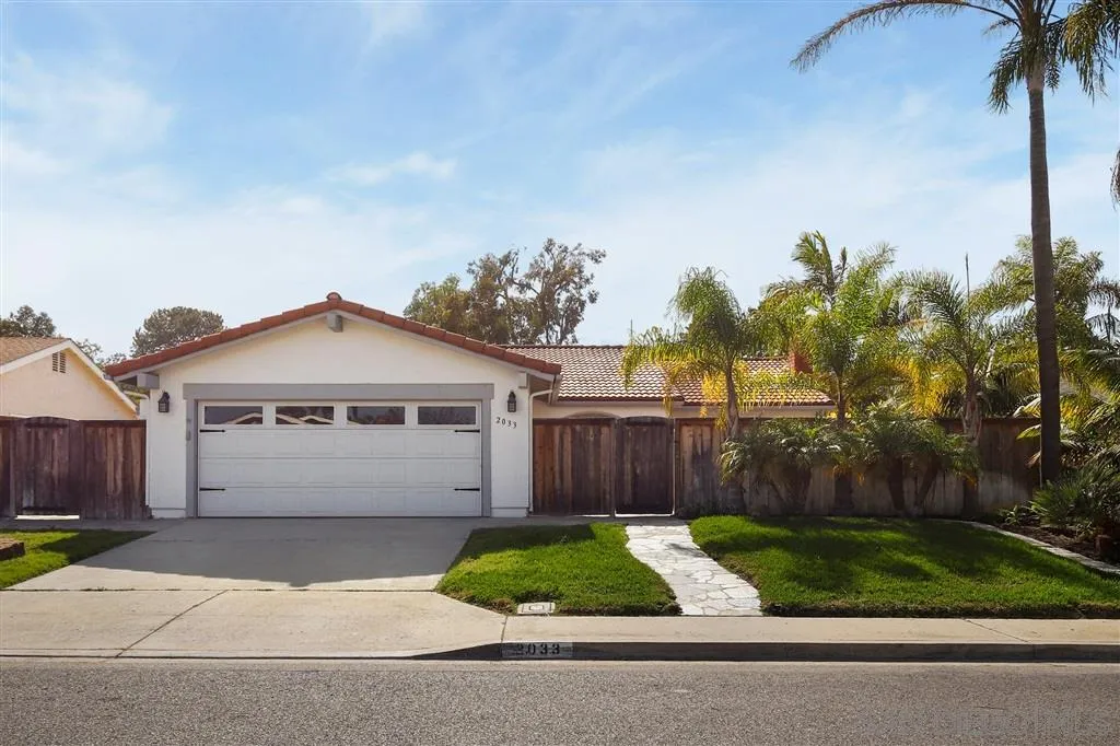 2033 Village Wood Road Encinitas, CA 92024 - Photo 1 of 25 a front view of a house with a garden and plants
