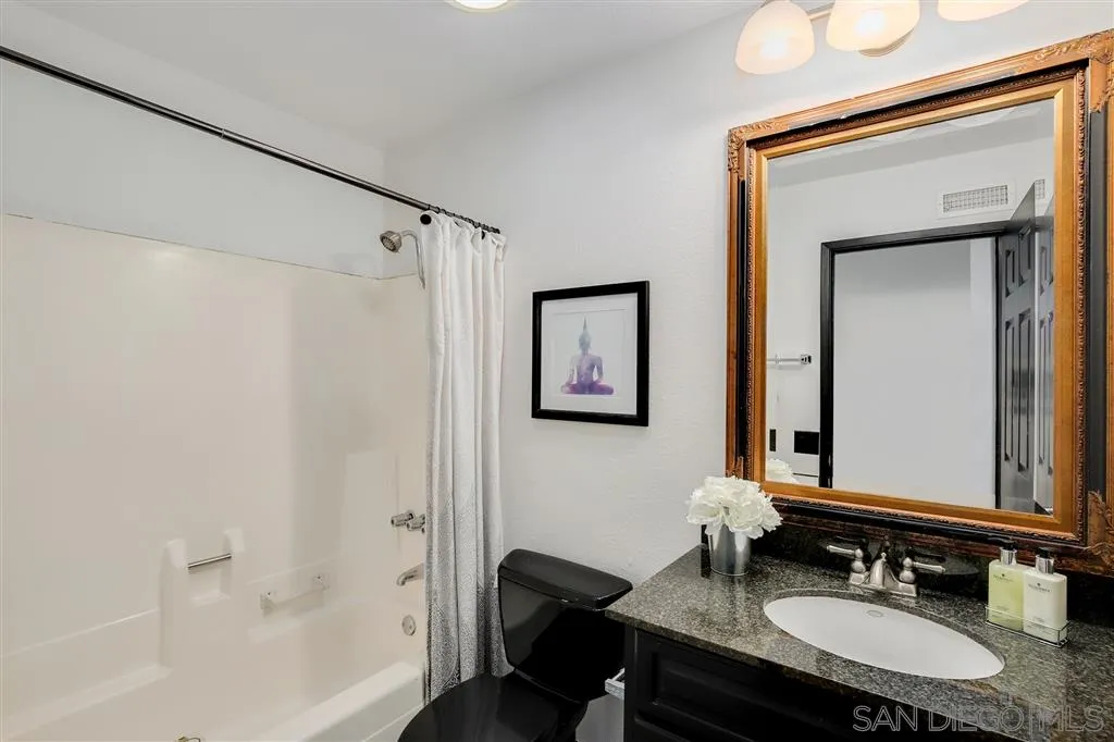 2033 Village Wood Road Encinitas, CA 92024 - Photo 22 of 25 a bathroom with a granite countertop sink mirror and a bathtub