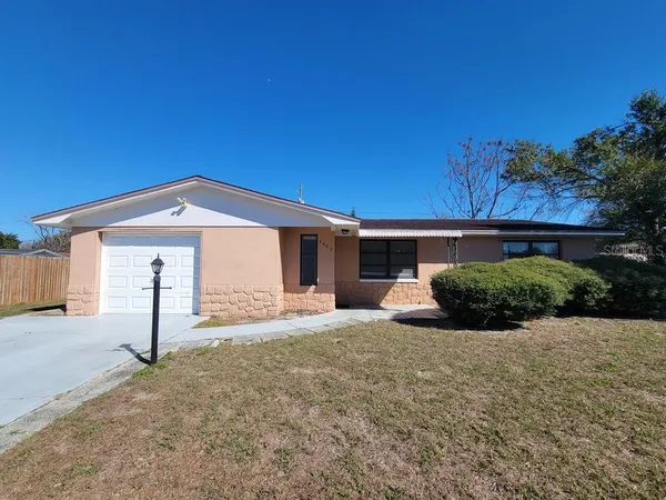 a view of a house with a yard and garage