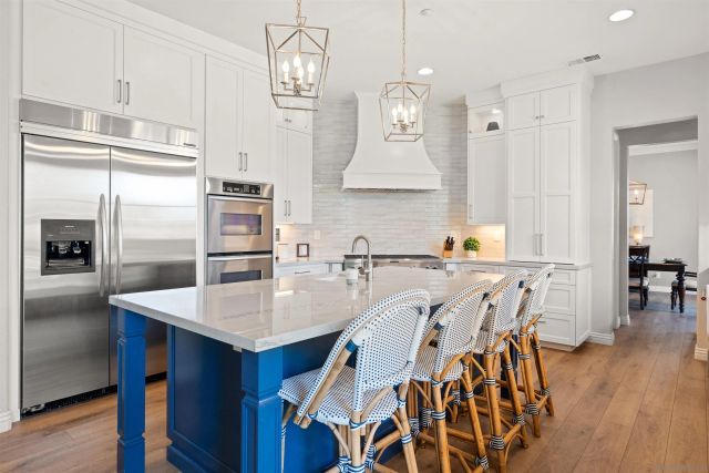 a large kitchen with a table and chairs