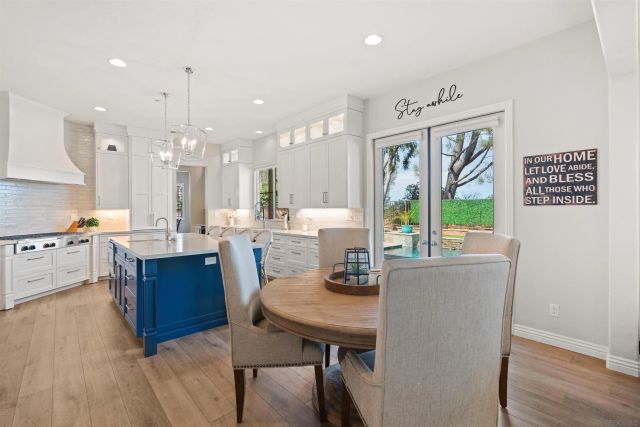 a living room with kitchen island furniture and a wooden floor