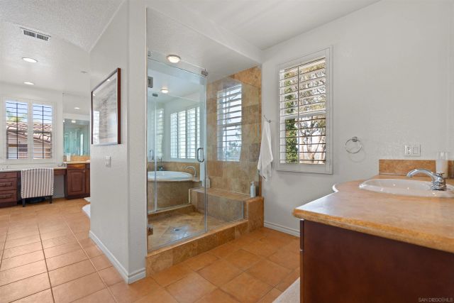 a bathroom with a tub sink and mirror