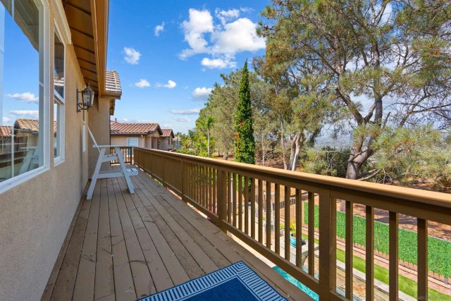 a view of balcony with wooden floor and fence