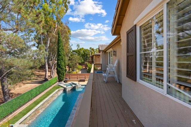 a view of a balcony with chairs and wooden floor