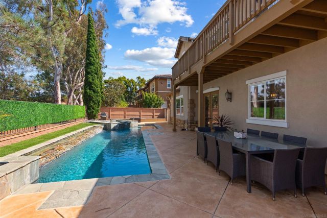 a view of a backyard with sitting area