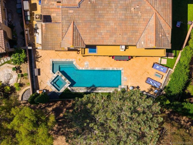 an aerial view of a house with a garden and swimming pool
