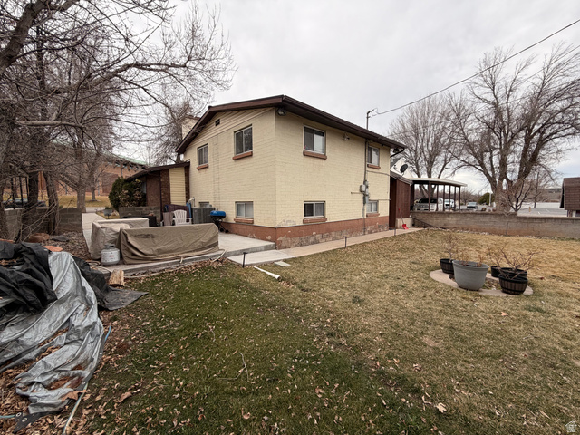 574 West Harding Avenue Cedar City, UT 84720 - Photo 27 of 43 View of property exterior featuring brick siding, a patio, and a fire pit