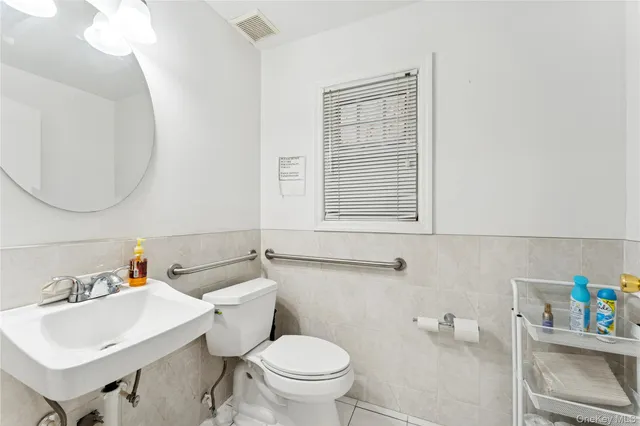 a bathroom with a sink toilet and a mirror