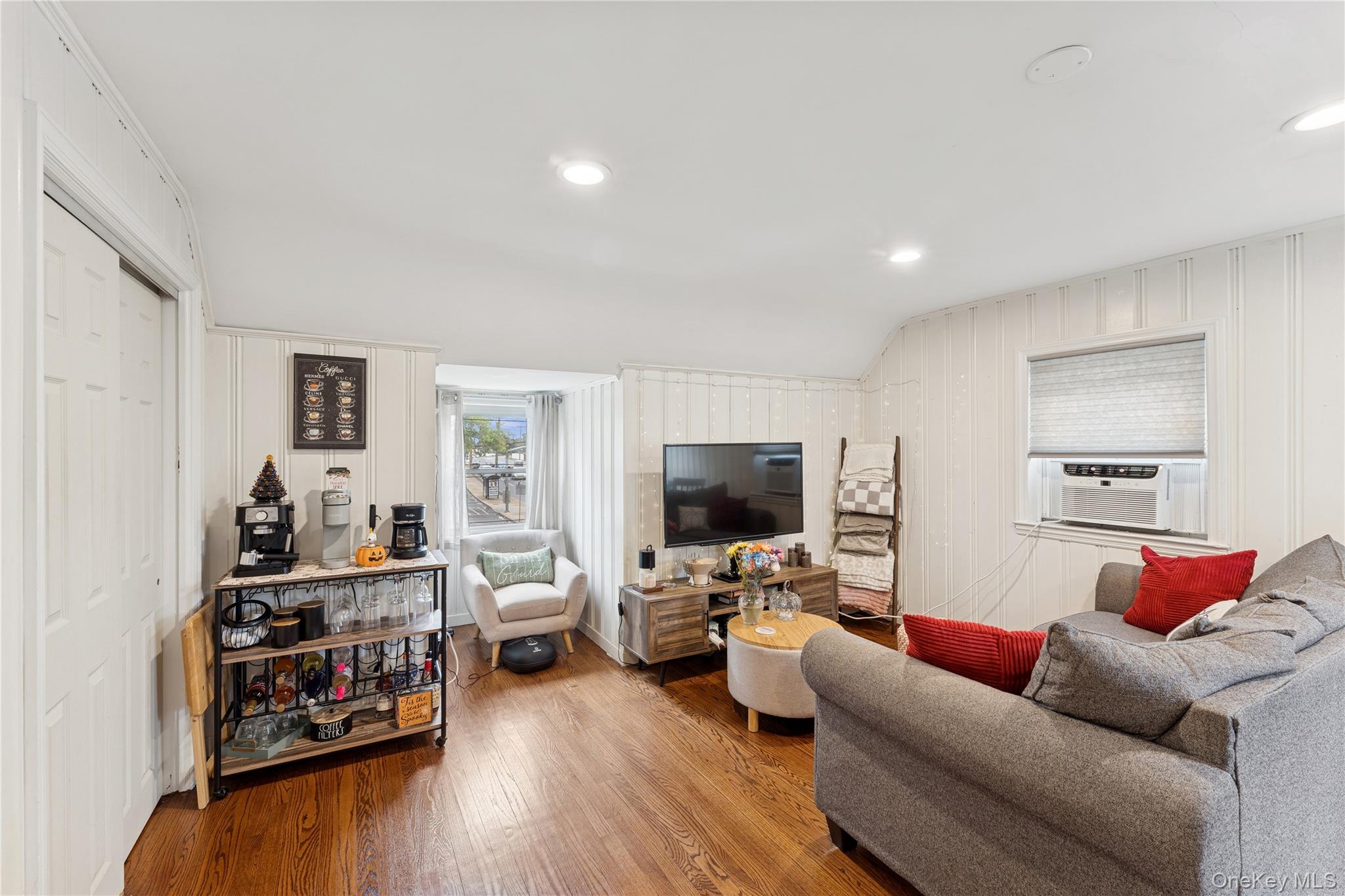 5 Seaton Gate Valley Stream, NY 11580 - Photo 23 of 36 a living room with furniture and a flat screen tv