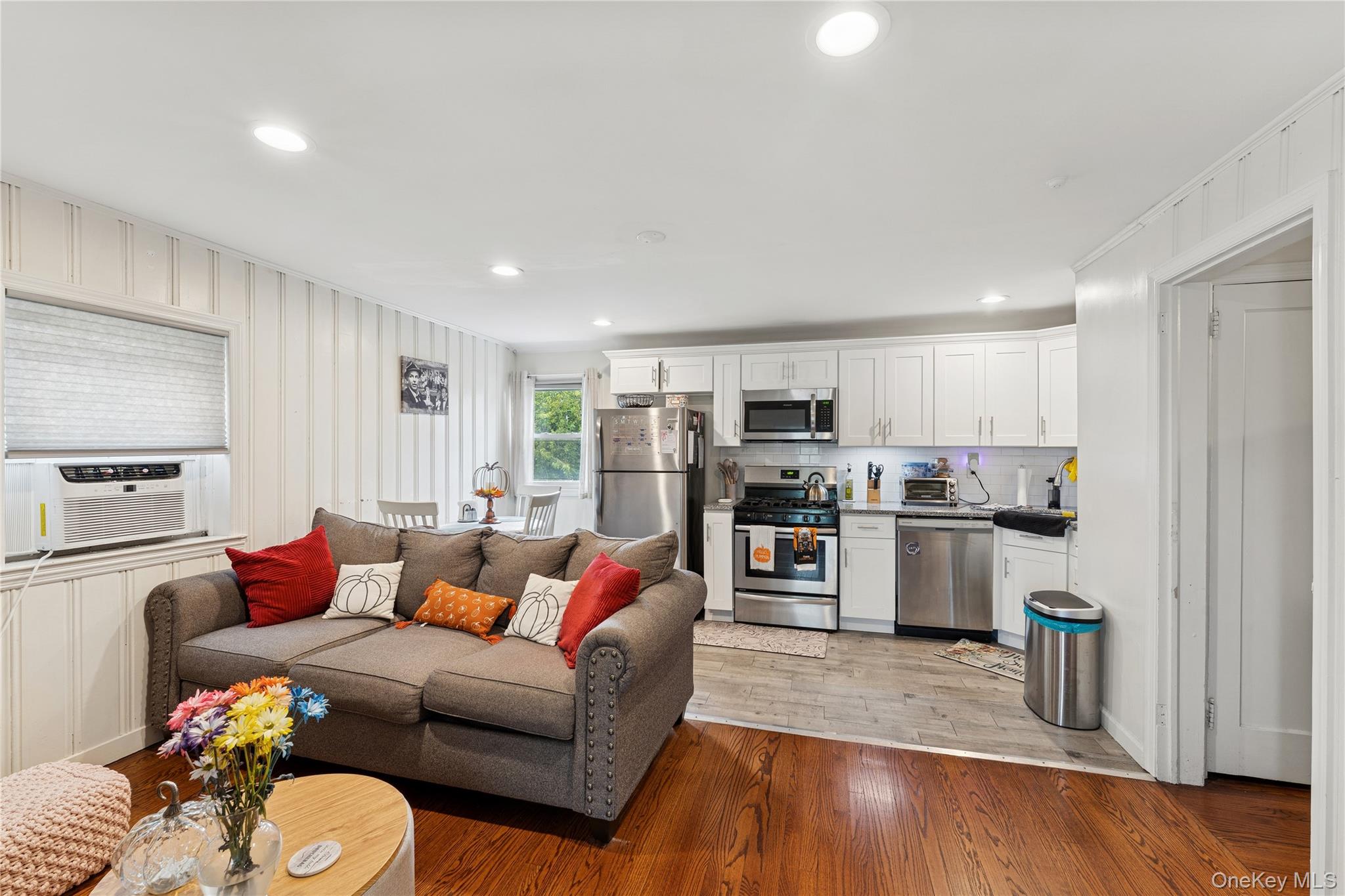 5 Seaton Gate Valley Stream, NY 11580 - Photo 24 of 36 a living room with furniture and kitchen view