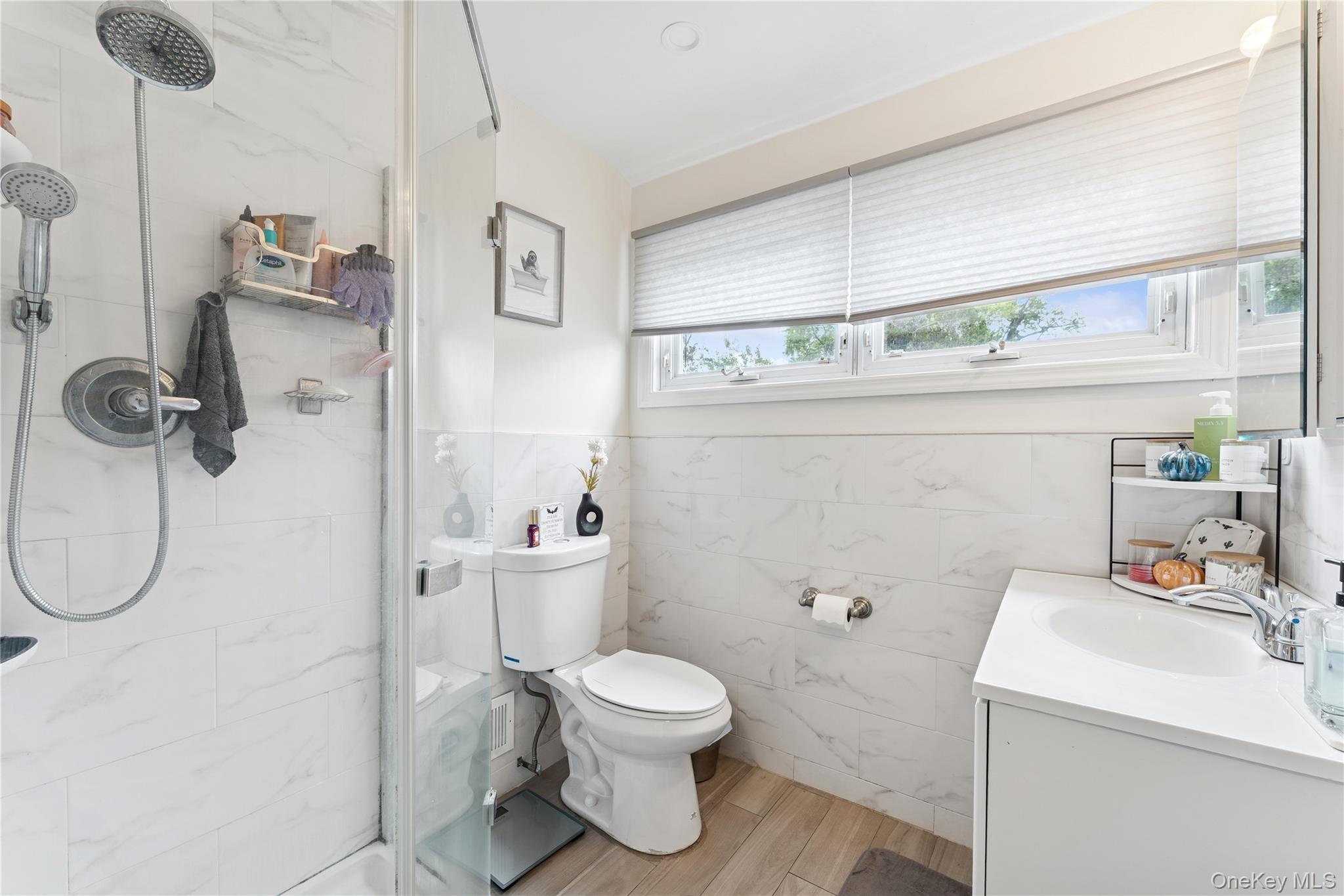 5 Seaton Gate Valley Stream, NY 11580 - Photo 30 of 36 a bathroom with a toilet sink and shower