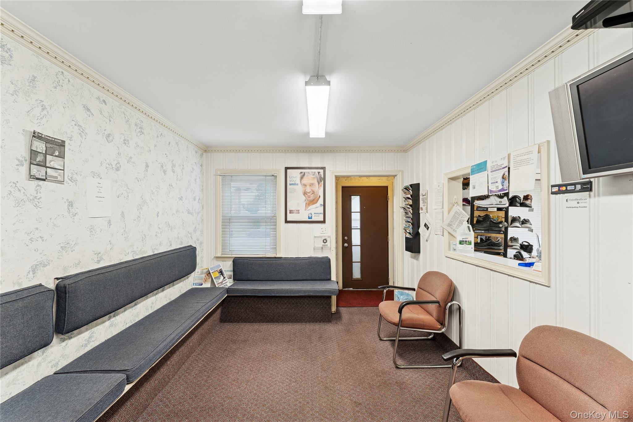 5 Seaton Gate Valley Stream, NY 11580 - Photo 5 of 36 a living room with furniture and a flat screen tv