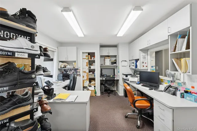 a view of a room with workspace and music instruments