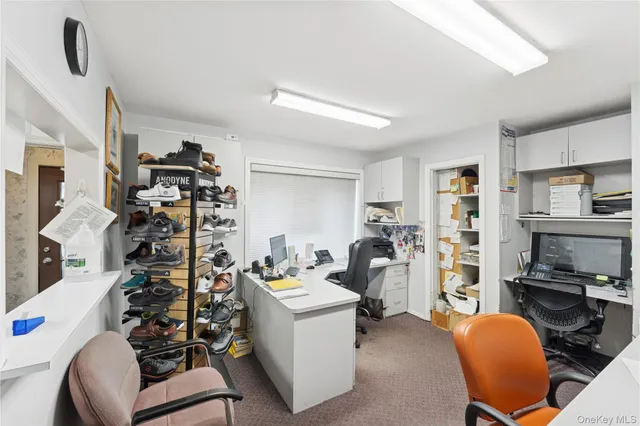 a view of a livingroom with workspace and a couch