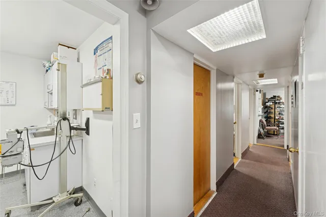 a view of a hallway with filled with furniture