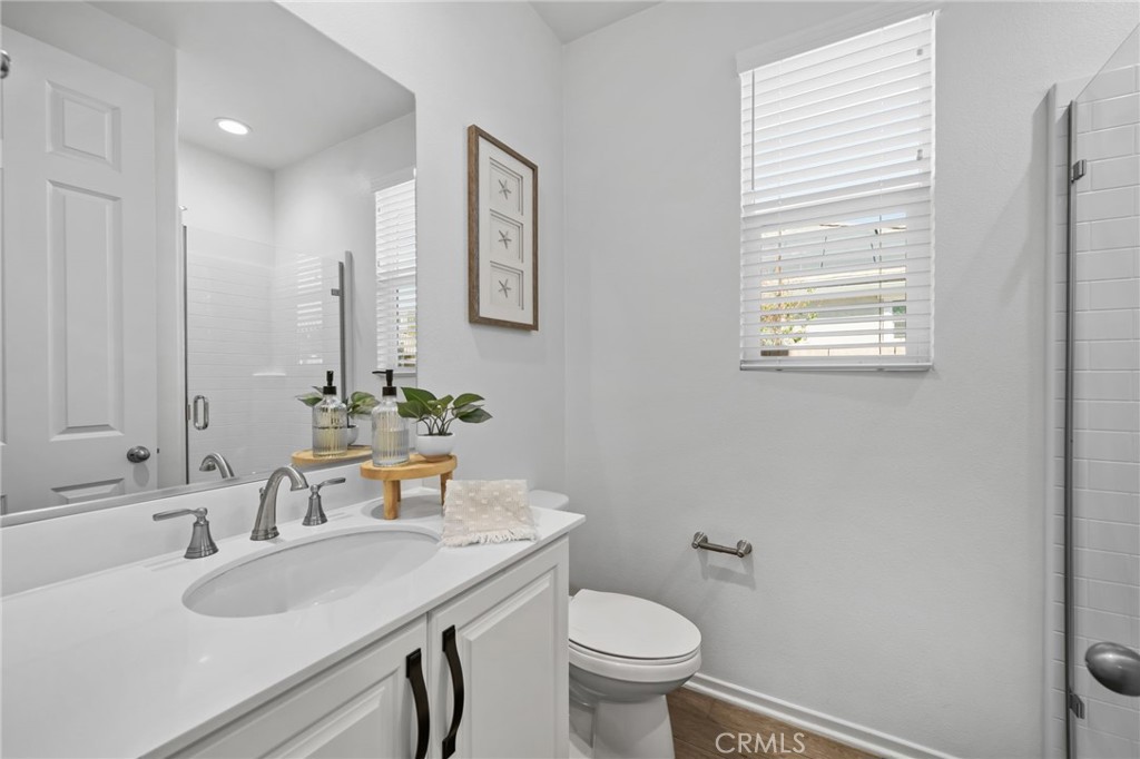 24085 Midvale Court Corona, CA 92883 - Photo 15 of 56 a bathroom with a sink toilet and a mirror
