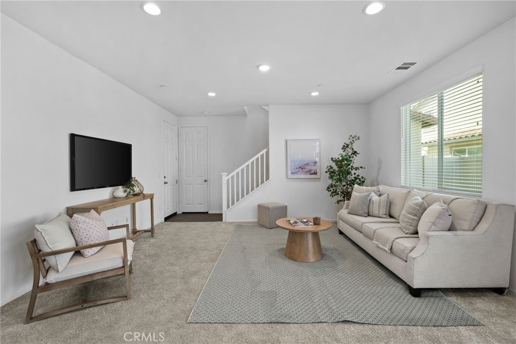 24085 Midvale Court Corona, CA 92883 - Photo 16 of 56 a living room with furniture and a flat screen tv
