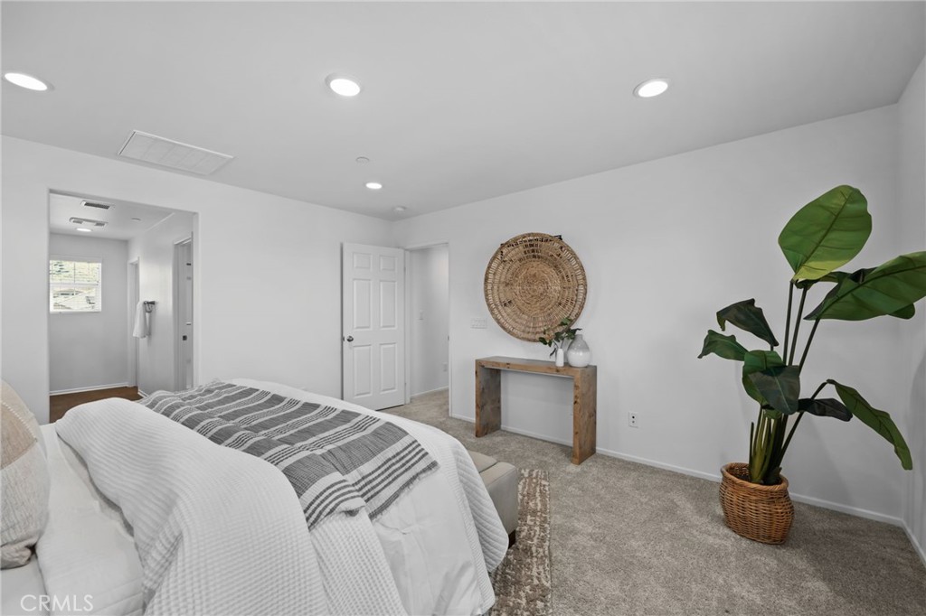 24085 Midvale Court Corona, CA 92883 - Photo 20 of 56 a bedroom with a bed and a potted plant