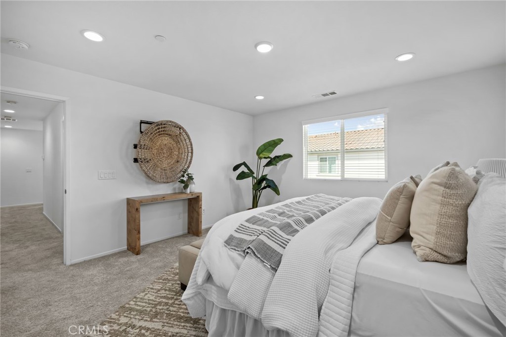 24085 Midvale Court Corona, CA 92883 - Photo 21 of 56 a bedroom with a large bed and a window