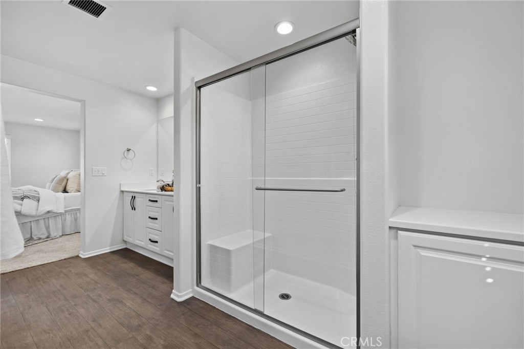 24085 Midvale Court Corona, CA 92883 - Photo 24 of 56 a bathroom with a glass shower door and a sink