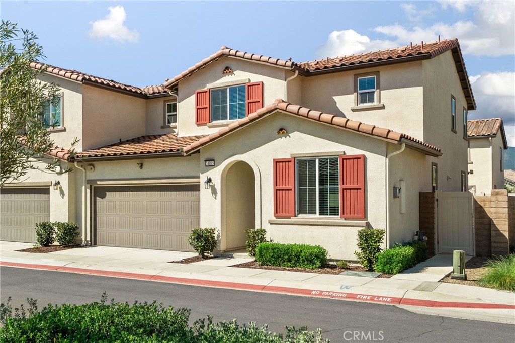 24085 Midvale Court Corona, CA 92883 - Photo 3 of 56 a front view of a house with a yard and garage
