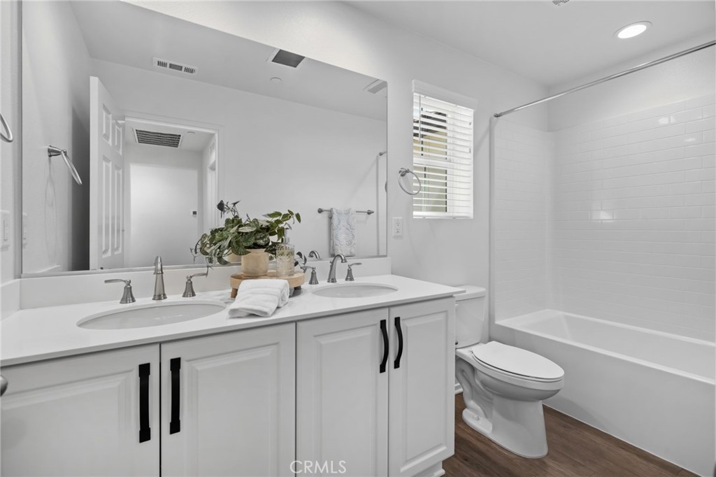 24085 Midvale Court Corona, CA 92883 - Photo 31 of 56 a bathroom with a sink toilet and shower