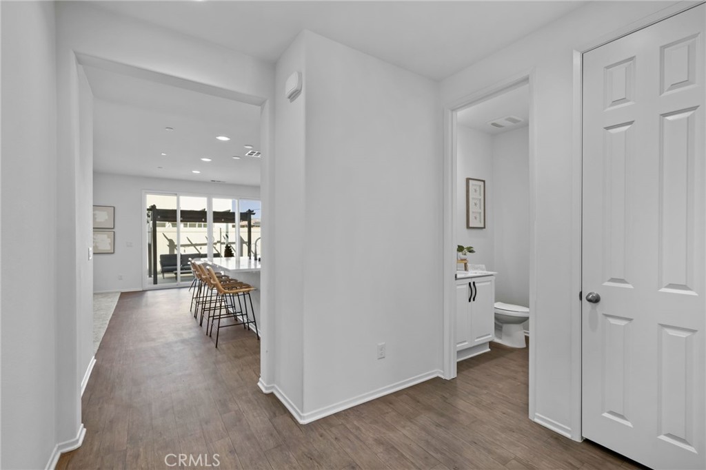 24085 Midvale Court Corona, CA 92883 - Photo 5 of 56 a view of a hallway with wooden floor and a bathroom