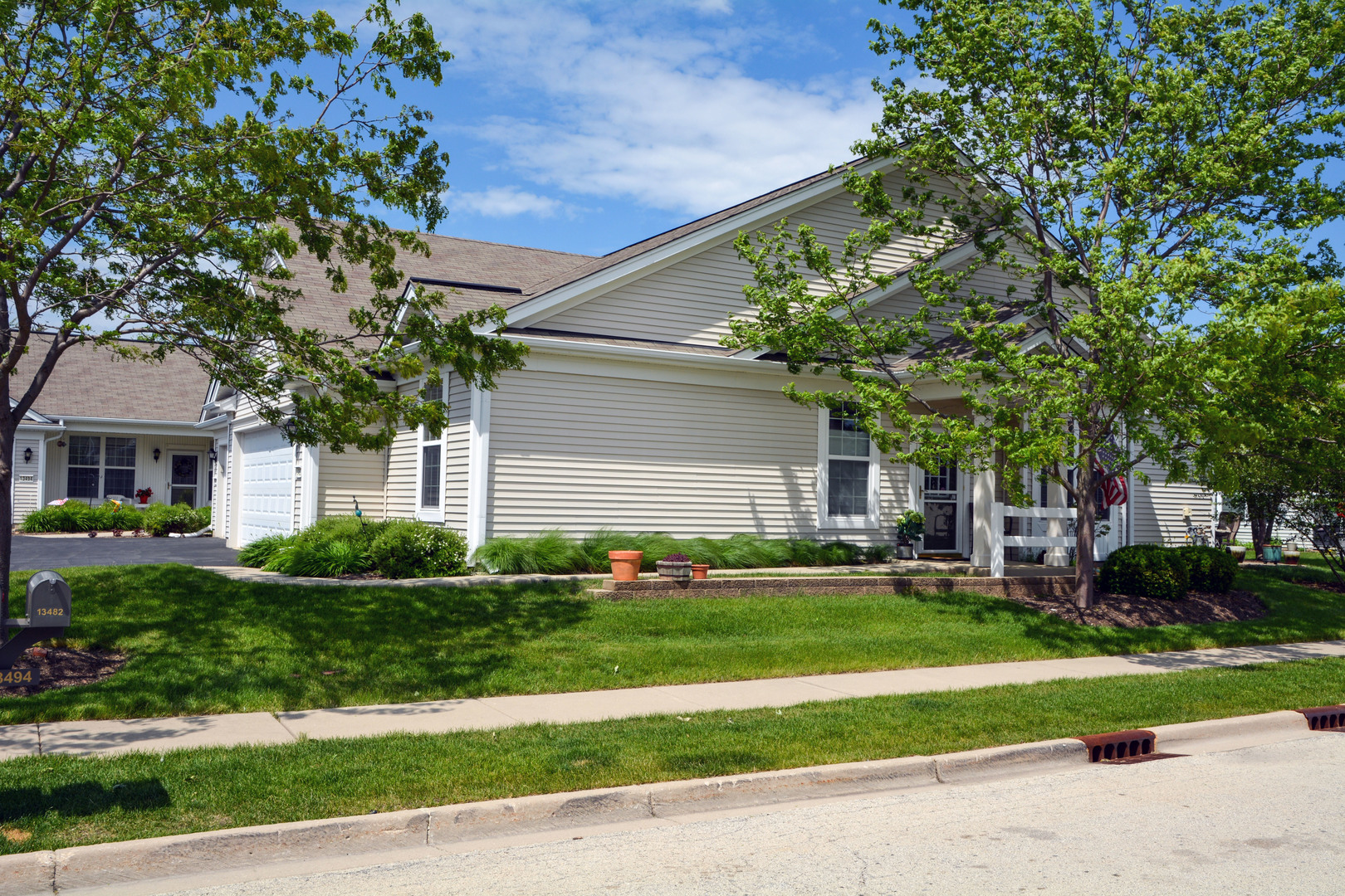 13482 Delaney Road Huntley, IL 60142 - Photo 18 of 18 a front view of a house with a yard and garage