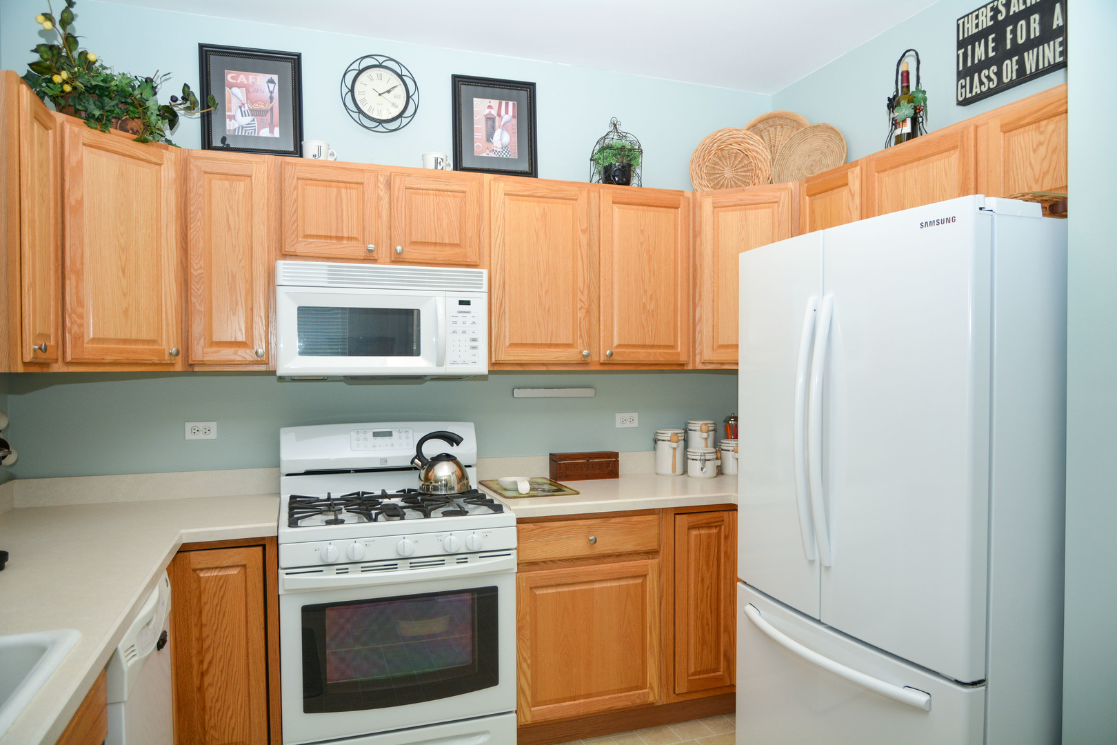 13482 Delaney Road Huntley, IL 60142 - Photo 9 of 18 a kitchen with stainless steel appliances white cabinets and a refrigerator