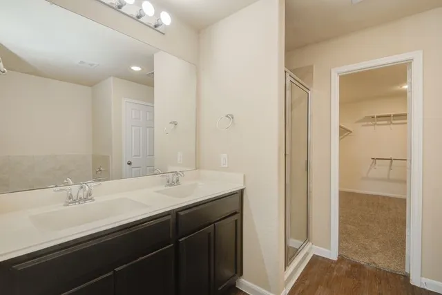 a bathroom with a sink double vanity and a mirror