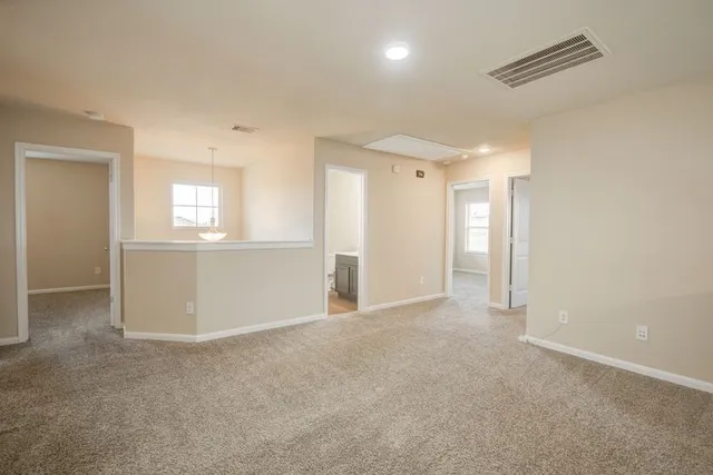 an empty room with windows and entrance