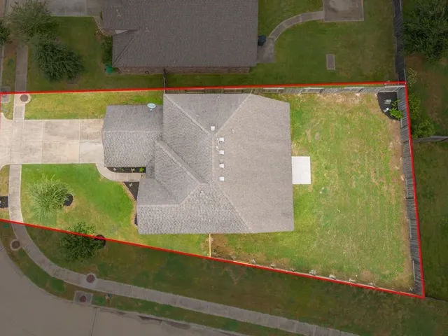 an aerial view of residential houses with outdoor space and swimming pool