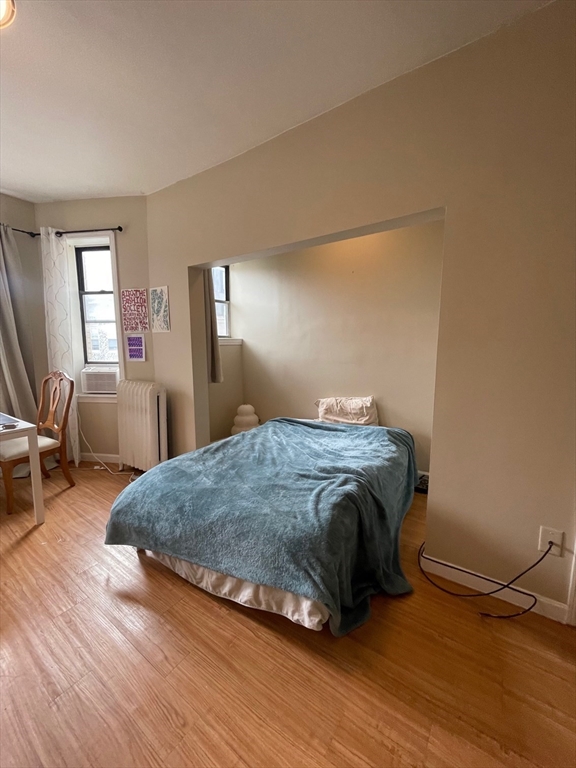 65 Burbank Street, Unit 26 Boston, MA 02115 - Photo 3 of 6 a bedroom with a bed and window