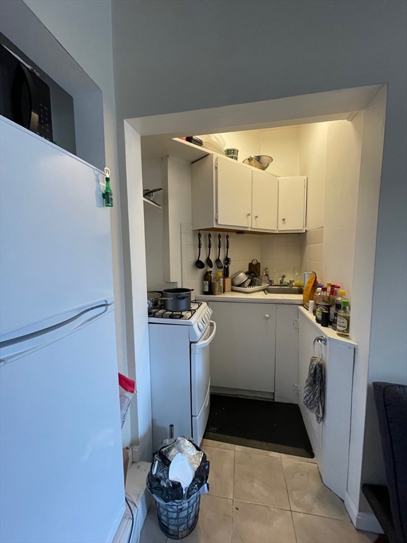 65 Burbank Street, Unit 26 Boston, MA 02115 - Photo 4 of 6 a kitchen with a sink appliances and cabinets