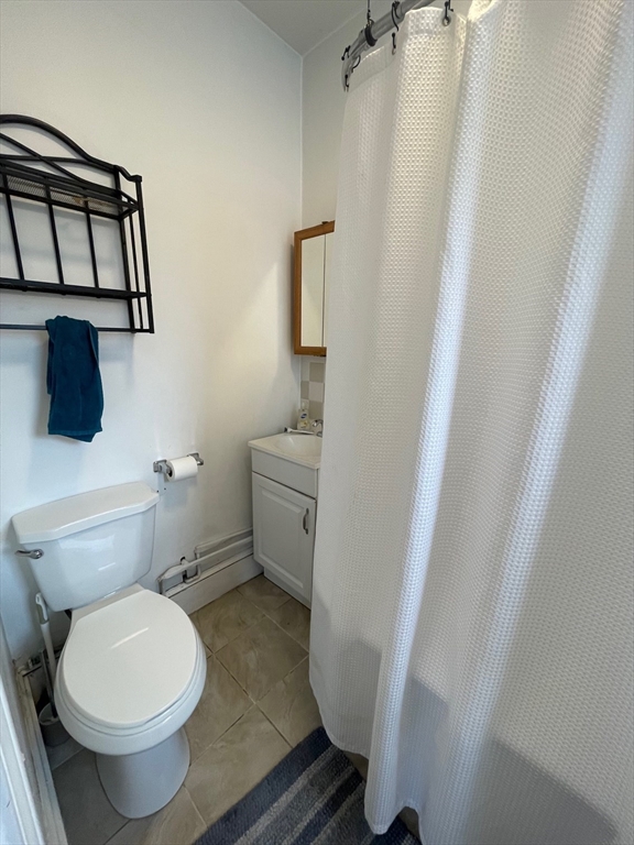 65 Burbank Street, Unit 26 Boston, MA 02115 - Photo 5 of 6 a bathroom with a toilet and a mirror