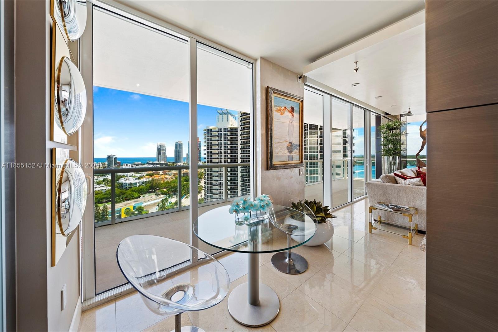 450 Alton Road, Unit 1907 Miami Beach, FL 33139 - Photo 15 of 64 a dining room with furniture and a floor to ceiling window