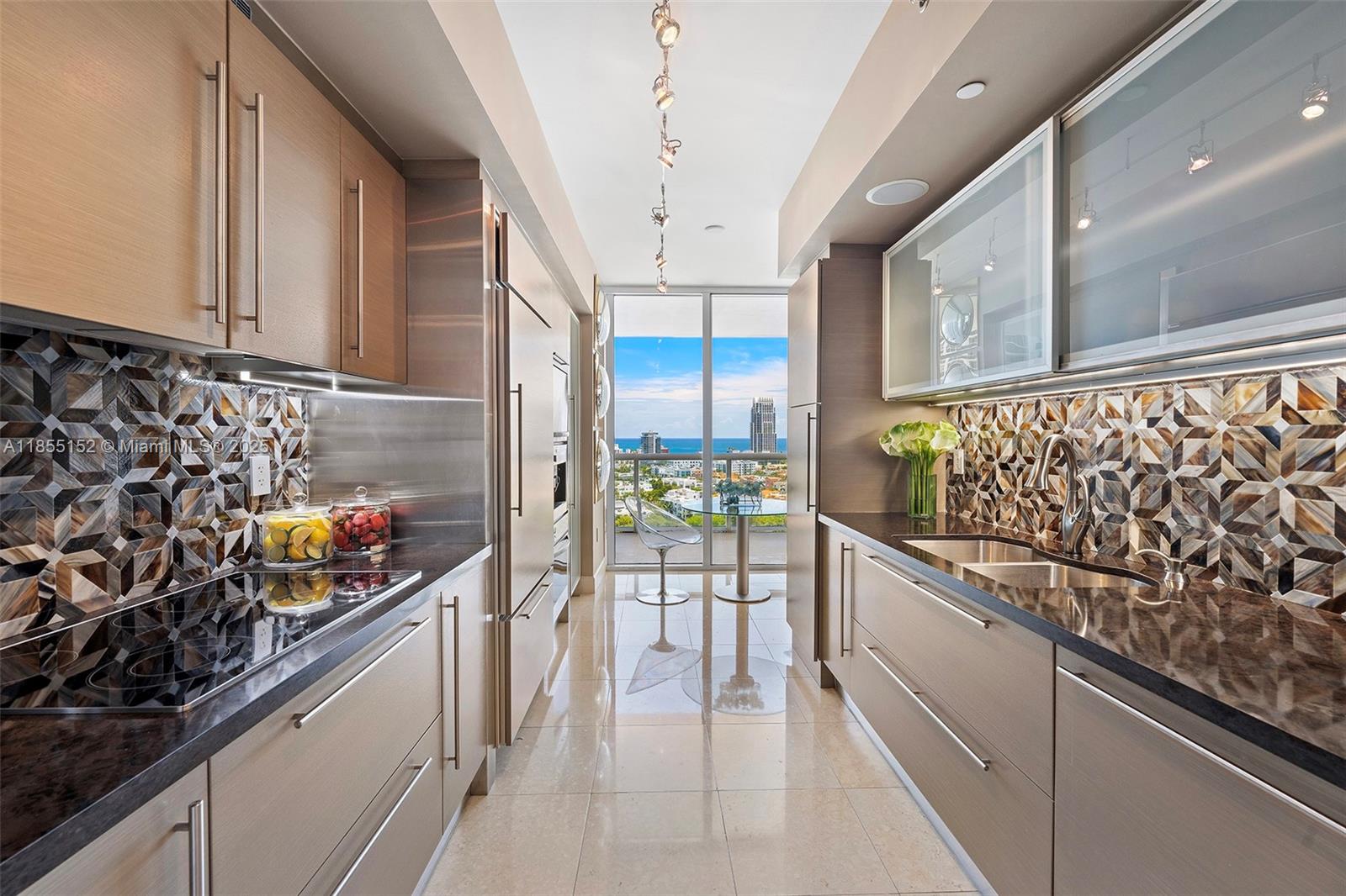 450 Alton Road, Unit 1907 Miami Beach, FL 33139 - Photo 16 of 64 a kitchen with stainless steel appliances a counter top space