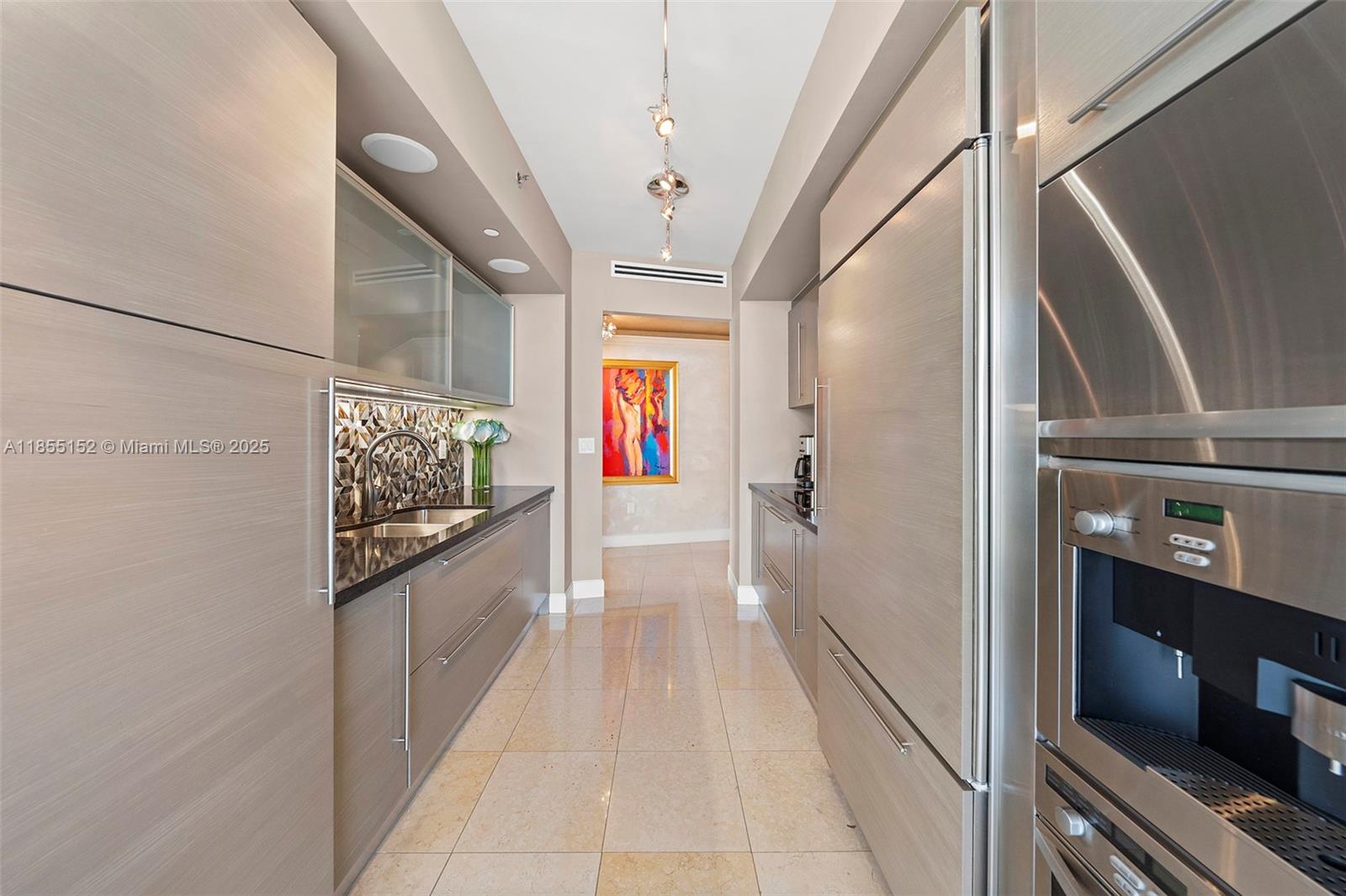450 Alton Road, Unit 1907 Miami Beach, FL 33139 - Photo 18 of 64 a hallway with wooden floor and furniture