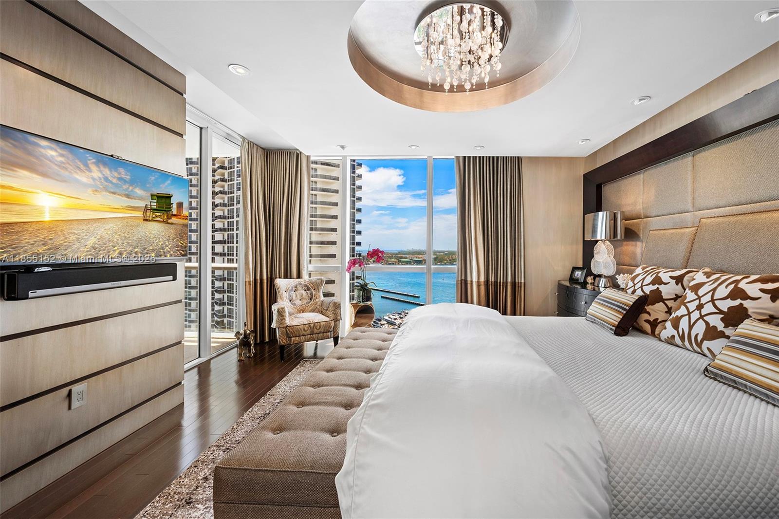 450 Alton Road, Unit 1907 Miami Beach, FL 33139 - Photo 24 of 64 a bedroom with a bed and a flat screen tv