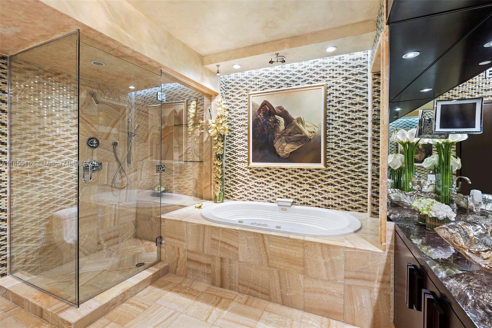 450 Alton Road, Unit 1907 Miami Beach, FL 33139 - Photo 31 of 64 a bathroom with a sink a mirror and a shower