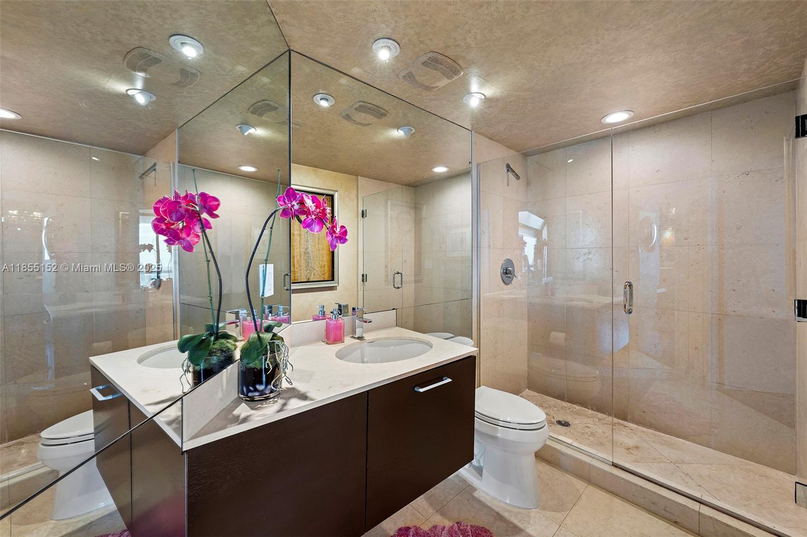 450 Alton Road, Unit 1907 Miami Beach, FL 33139 - Photo 37 of 64 a bathroom with a sink vanity mirror and toilet