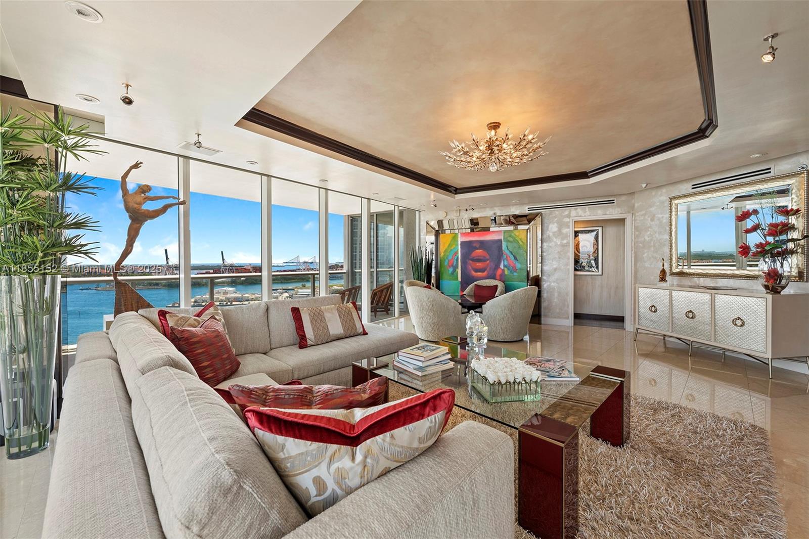 450 Alton Road, Unit 1907 Miami Beach, FL 33139 - Photo 7 of 64 a living room with furniture a chandelier and a rug