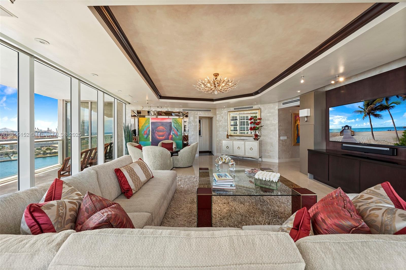 450 Alton Road, Unit 1907 Miami Beach, FL 33139 - Photo 9 of 64 a living room with furniture and a flat screen tv