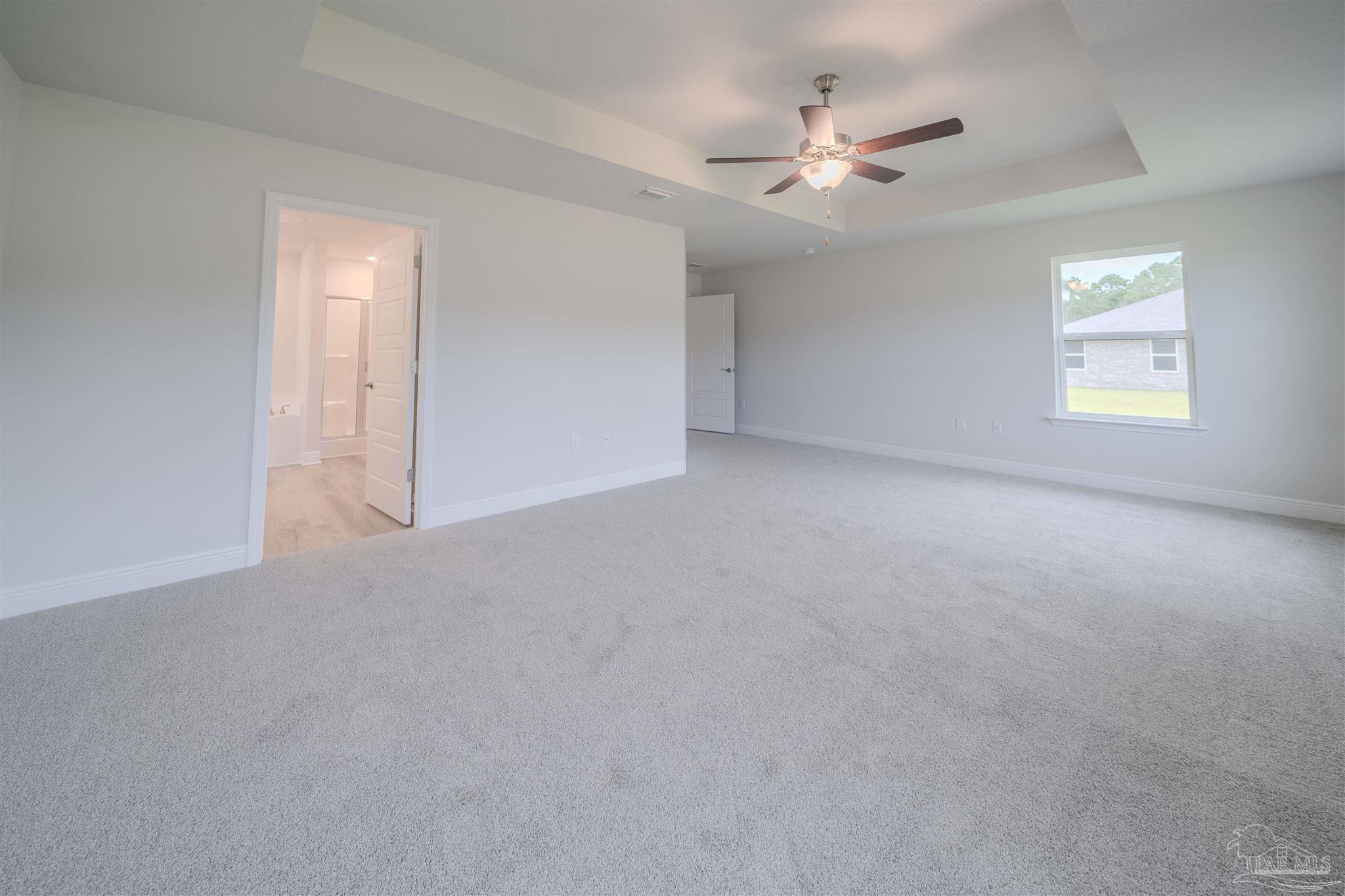 1730 Leigh Loop, Unit 18D Cantonment, FL 32533 - Photo 11 of 18 an empty room with windows and ceiling fan