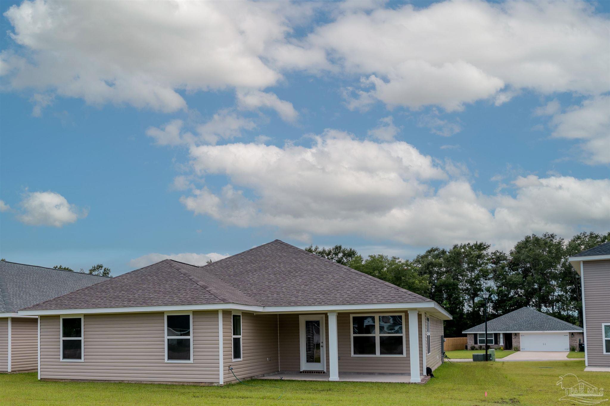 1730 Leigh Loop, Unit 18D Cantonment, FL 32533 - Photo 17 of 18 a front view of a house with garden