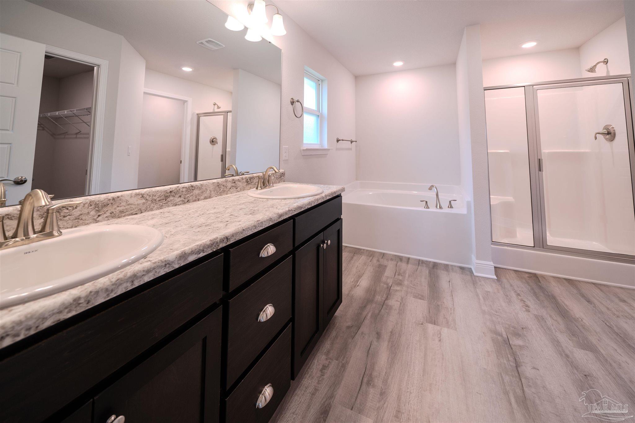 1730 Leigh Loop, Unit 18D Cantonment, FL 32533 - Photo 3 of 18 a bathroom with a granite countertop sink a toilet a large mirror and shower