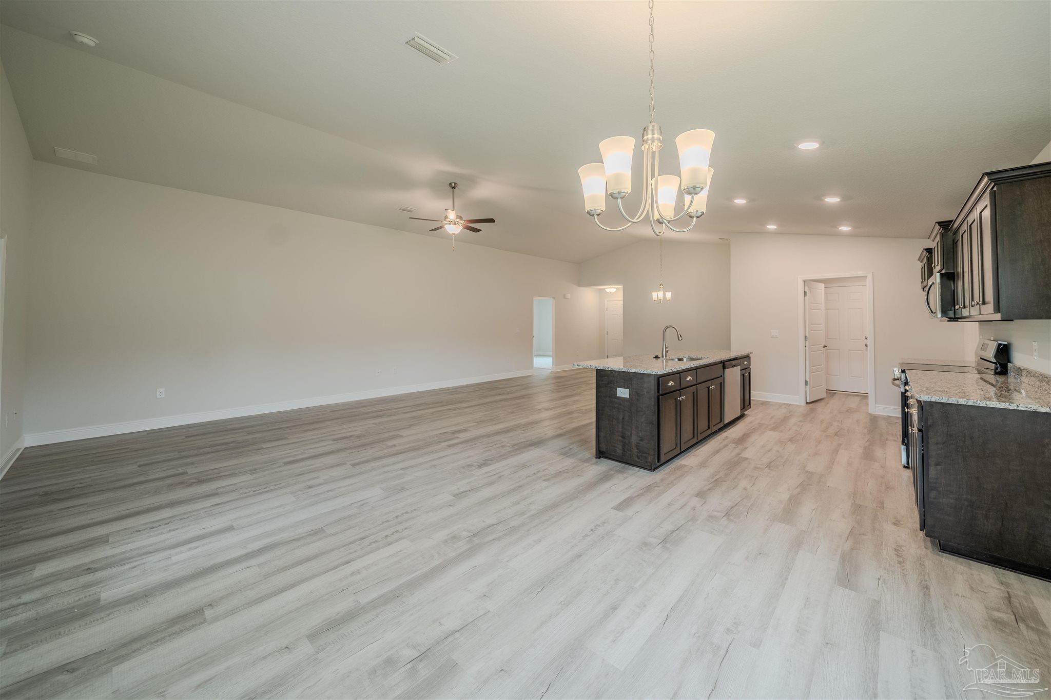 1730 Leigh Loop, Unit 18D Cantonment, FL 32533 - Photo 7 of 18 a room with hard wood floors and a kitchen