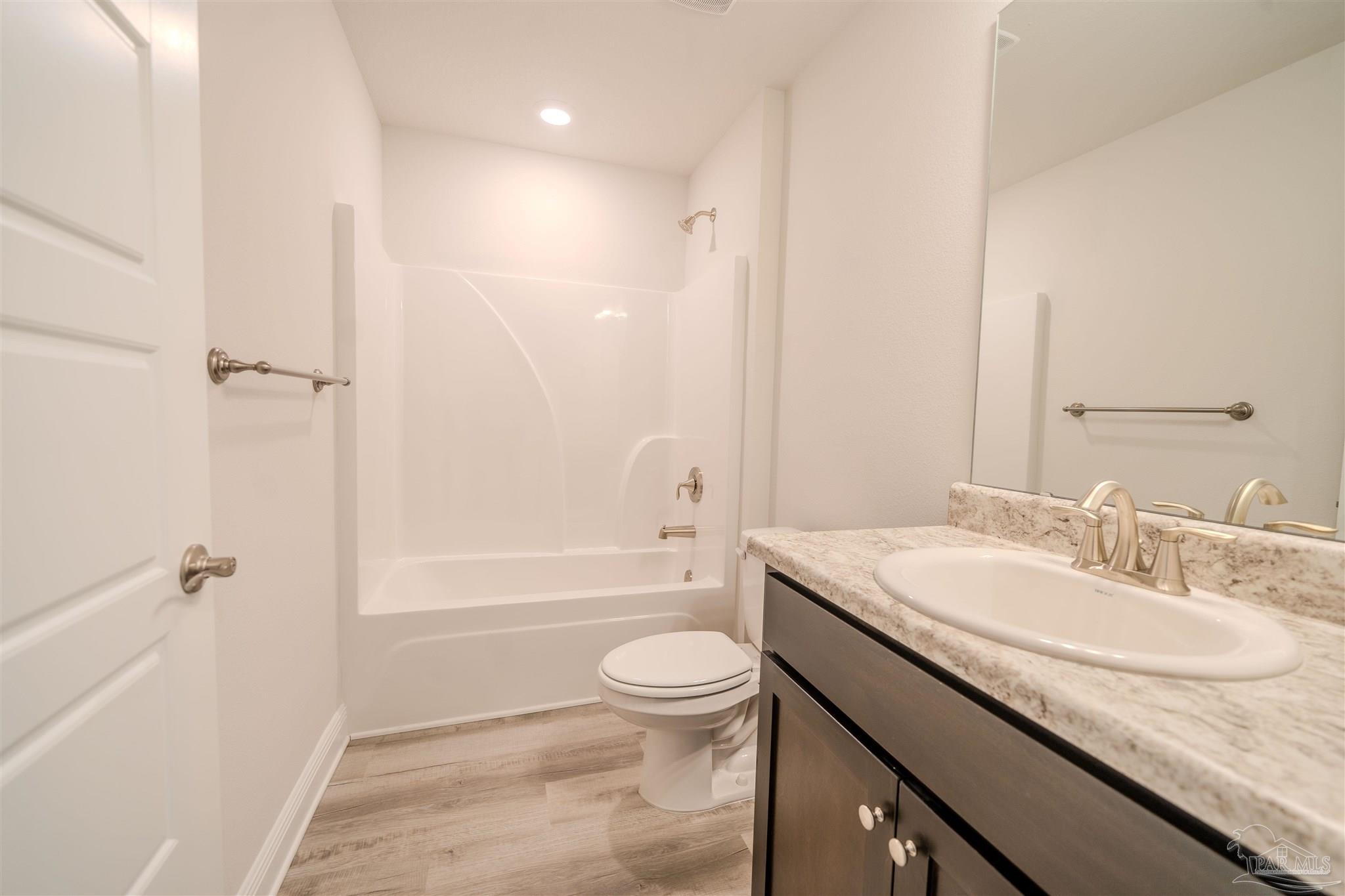 1730 Leigh Loop, Unit 18D Cantonment, FL 32533 - Photo 10 of 18 a bathroom with a granite countertop sink a toilet and shower