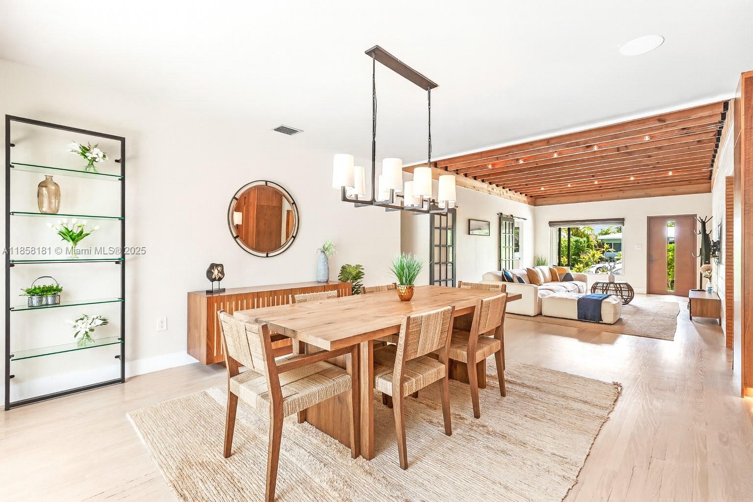 9065 Emerson Avenue Surfside, FL 33154 - Photo 13 of 50 a view of a dining room with furniture window and wooden floor