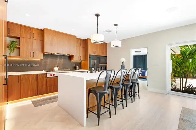 a kitchen with a table chairs and entryway